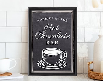 May include: Black framed sign with white text that reads "Warm up at the Hot Chocolate Bar". A white cup of hot chocolate is illustrated on the sign.
