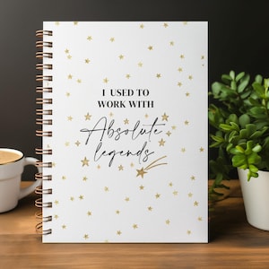 May include: A white spiral-bound notebook featuring a pattern of small gold stars and a shooting star. The text printed in the centre reads I USED TO WORK WITH Absolute legends in a combination of bold block letters and a black cursive script.