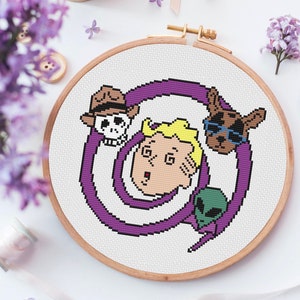 May include: A cross-stitch embroidery hoop with a purple spiral design. The spiral surrounds a cartoon character with blonde hair, a skull, a dog wearing sunglasses, and an alien.