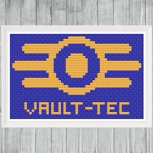 May include: Cross-stitch art featuring the Vault-Tec logo in gold and blue. The logo is centered on a blue background, with the words "VAULT-TEC" stitched below. The artwork is framed in a white border.