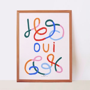 Colourful printed wall art with positive phrase in French