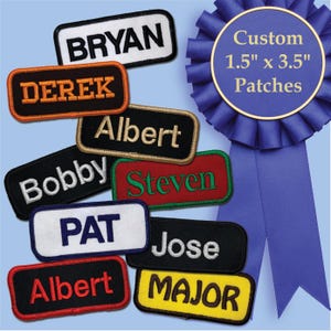 May include: A collection of embroidered name patches in various colors, including black, white, red, and yellow. Each patch features a different name in contrasting thread. A blue ribbon with text that reads "Custom 1.5" x 3.5" Patches" is also visible.