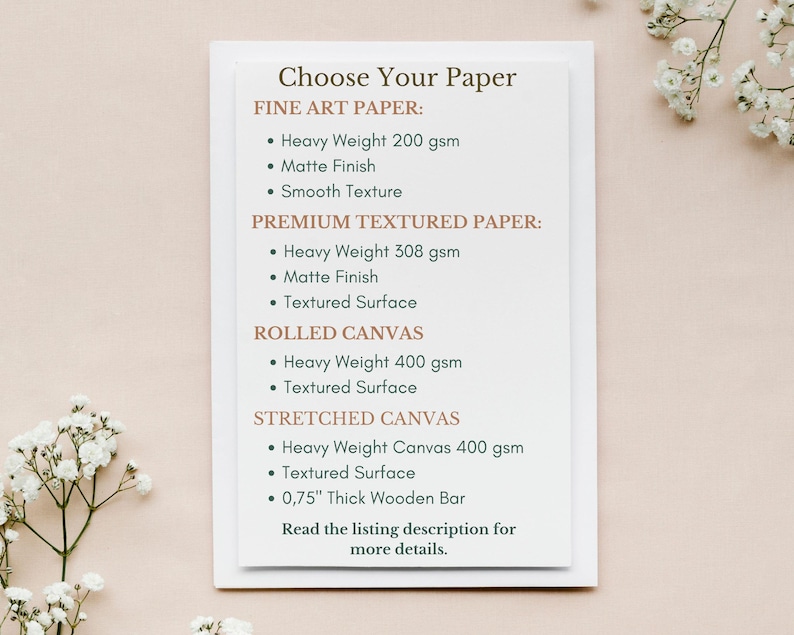 May include: A white card with the text "Choose Your Paper" in brown text. The card lists different paper and canvas options for prints, including fine art paper, premium textured paper, rolled canvas, and stretched canvas. Each option lists the weight of the paper or canvas in grams per square meter (gsm) and the surface texture.