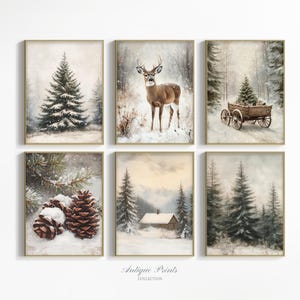 May include: A set of six framed antique prints showcasing winter scenes. The prints feature snowy landscapes with pine trees, a deer, a cabin, and a wooden cart. The prints have a vintage aesthetic with a soft colour palette.
