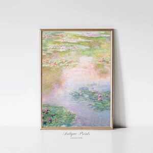 May include: A framed print of a painting depicting a pond with water lilies and pink flowers. The water is a light blue and the lilies are green. The background is a soft, pastel pink and green.