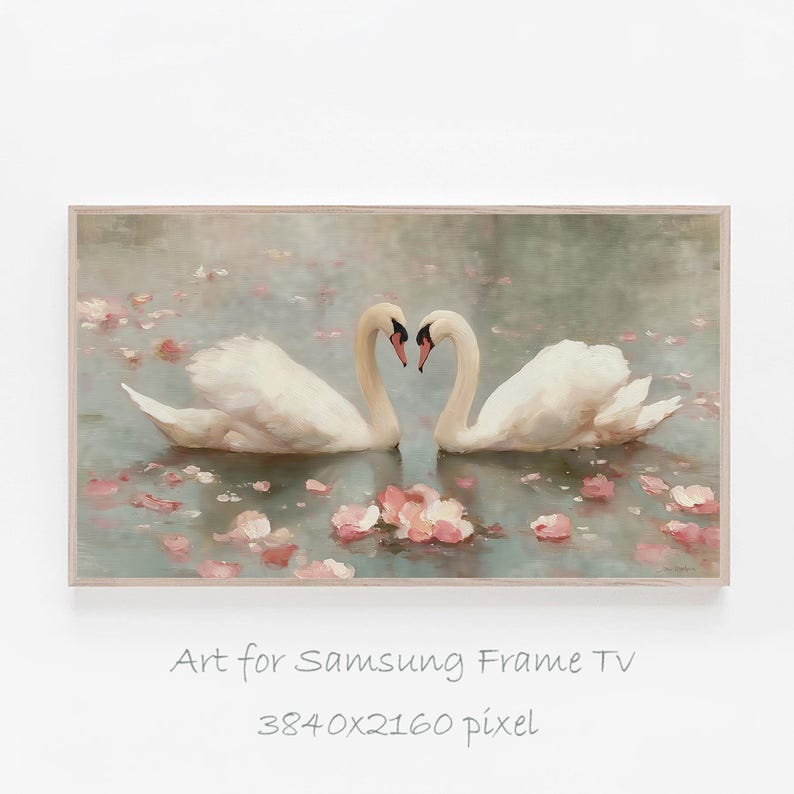 May include: A framed digital art print for Samsung Frame TV. The artwork depicts two white swans with curved necks forming a heart shape. Pink flower petals float on the water. The background is a soft, muted color palette.