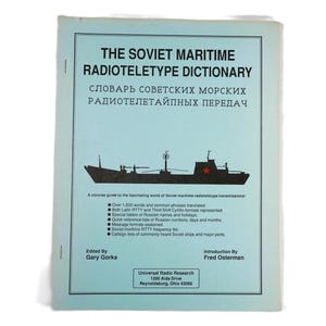 May include: A blue book titled "The Soviet Maritime Radioteletype Dictionary" with a Russian translation of the title. The book cover features a black and white illustration of a Soviet ship with a red star on the stern.