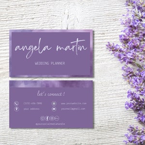 May include: A purple business card with a watercolour background. The text on the card reads "angela martin" and "wedding planner". The back of the card has contact information, including a phone number, website address, email address, and social media handles.