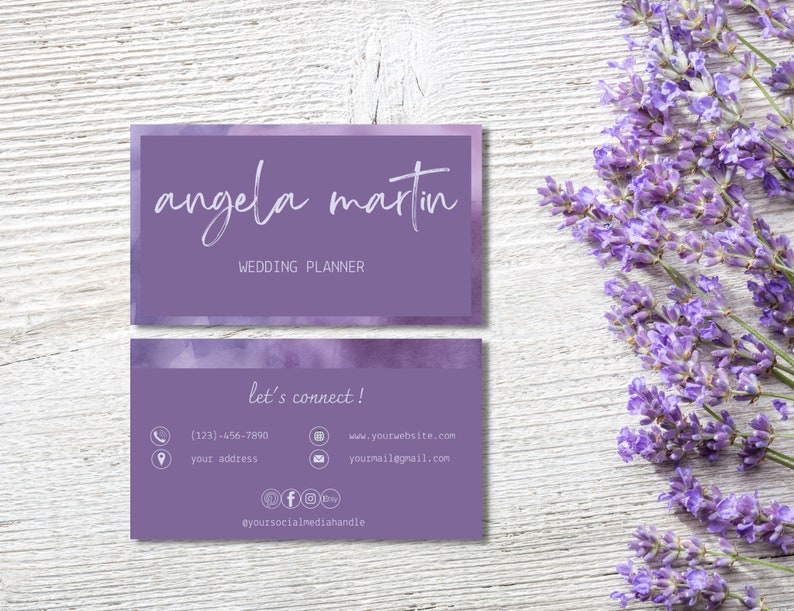 May include: A purple business card with a watercolour background. The text on the card reads "angela martin" and "wedding planner". The back of the card has contact information, including a phone number, website address, email address, and social media handles.