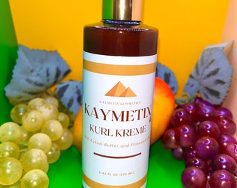 May include: A brown bottle with a gold pump top and a white label. The label says "KAYMETIX KOSMETICS KAYMETIX KURL KREME with Kokum Butter and Flaxseed Oil 8.45 FL OZ (250 ML)".