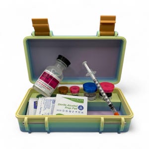 May include: A medical kit with a yellow and blue case, containing a bottle labeled "Bacteriostatic Water", syringes, vials, and alcohol prep pads. The kit has a handle and is open, displaying the contents.