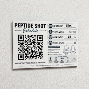 May include: A white rectangular magnetic peptide shot schedule board with black text and graphics. It features a large QR code, fields for next dose, current dose, and weight goals in lbs, a body diagram for injection sites, and tips for success.