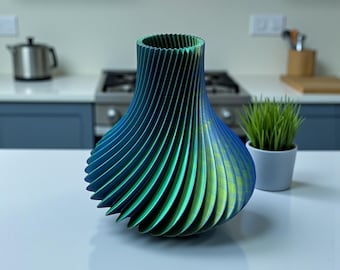 May include: A 3D printed vase with a spiraling, ribbed texture that transitions in color from deep blue to vibrant green. The vase features a wide, rounded base that tapers upward to a circular opening, showcasing a gradient finish.
