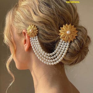 May include: Gold-coloured hair accessories with pearl strands. Each piece features a sunburst design with a central pearl. The accessories are attached to the hair, with multiple strands of pearls cascading down. The image is generated with AI for style reference.
