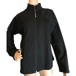 May include: A black zip-up jacket with a stand-up collar and long sleeves.