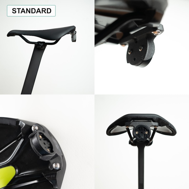 May include: A black bicycle saddle mounted on a seat post, featuring a standard integrated circular mounting bracket attached to the rear rails. The assembly includes metal hardware and a black plastic base, with the text STANDARD visible in the corner.