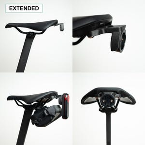 May include: A black bicycle saddle mount labeled EXTENDED, featuring a rear-facing attachment point for accessories. The mount is shown installed under a black bike seat, with views demonstrating its compatibility with a rear light and a saddle bag.