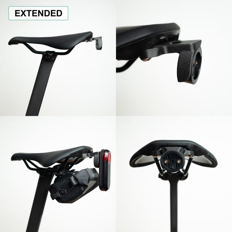 May include: A black bicycle saddle mount labeled EXTENDED, featuring a rear-facing attachment point for accessories. The mount is shown installed under a black bike seat, with views demonstrating its compatibility with a rear light and a saddle bag.