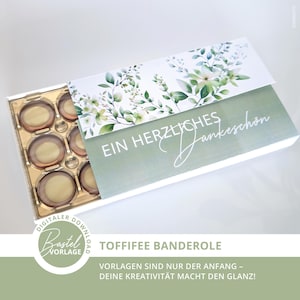 Könnte beinhalten: Eine Geschenkbox mit floralem Design und dem Schriftzug "EIN HERZLICHES Dankeschön" in weißer Schrift. Die Box enthält mehrere Pralinen. Auf der Unterseite der Box steht "TOFFIFEE BANDEROLE".