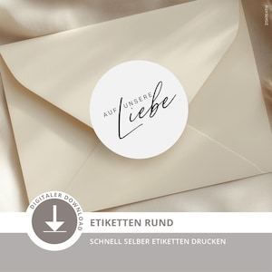 May include: A round white sticker featuring the black text "AUF UNSERE Liebe" in a mix of sans-serif and script fonts, centered on a cream-colored envelope. The sticker is a digital download design for printing round labels at home.