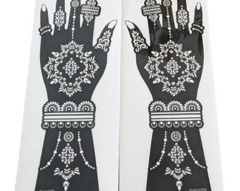 May include: Two black henna tattoo stencils with intricate designs of hands and floral patterns. The stencils are on a white background.