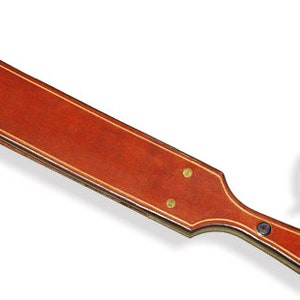 The Small Straddle a Cross Between a Leather Strap and a Leather Paddle ...