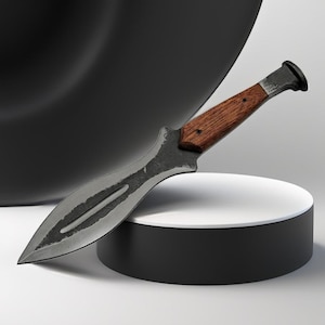 May include: A handcrafted knife with a dark, textured blade and a wooden handle. The blade has a curved shape with a central groove. The handle is a warm brown color, and the knife appears to be made of metal and wood.
