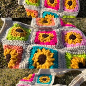 May include: A handmade crochet tote bag featuring a colorful sunflower design. The bag is made of squares in various colors, including yellow, pink, green, and orange, with a neutral-colored border and straps. The sunflowers have brown centers.
