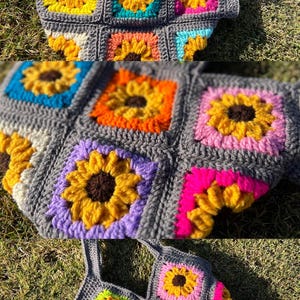 May include: A handmade crochet tote bag featuring a sunflower design. The bag is made of gray yarn with colorful squares of yellow, orange, pink, blue, and purple sunflowers. The bag has a matching gray strap.