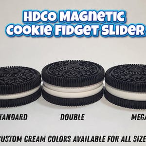 May include: Three round black and white magnetic cookie fidget sliders labeled HDCO MAGNETIC COOKIE FIDGET SLIDER. The items are labeled STANDARD, DOUBLE, and MEGA with the text CUSTOM CREAM COLORS AVAILABLE FOR ALL SIZES printed below them.