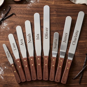 May include: A set of three ceramic mugs with a speckled, matte finish. The mugs are in shades of cream, light gray, and dark gray. Each mug has a simple, minimalist design, perfect for coffee or tea.