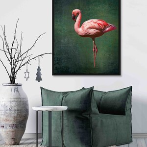 May include: A framed print of a pink flamingo standing on one leg against a green background.