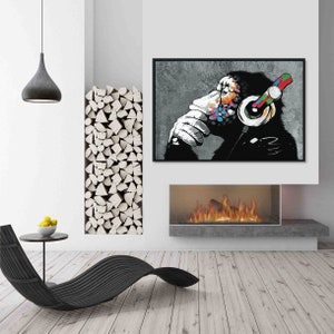 May include: A black and white illustration of a monkey wearing headphones with colorful accents. The monkey is sitting and thinking, with its hand on its chin. The background is a gray concrete wall.