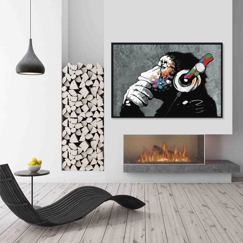 May include: A black and white illustration of a monkey wearing headphones with colorful accents. The monkey is sitting and thinking, with its hand on its chin. The background is a gray concrete wall.