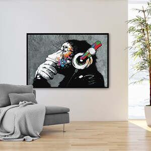 May include: A black and white illustration of a monkey wearing colorful headphones. The monkey is sitting with its chin on its hand, looking thoughtful. The background is a gray, textured surface.