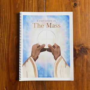 May include: A white booklet with a spiral binding titled "A Unit Study on The Mass" with an illustration of hands holding a white communion wafer. The text "Into the Deep" is at the bottom of the cover.
