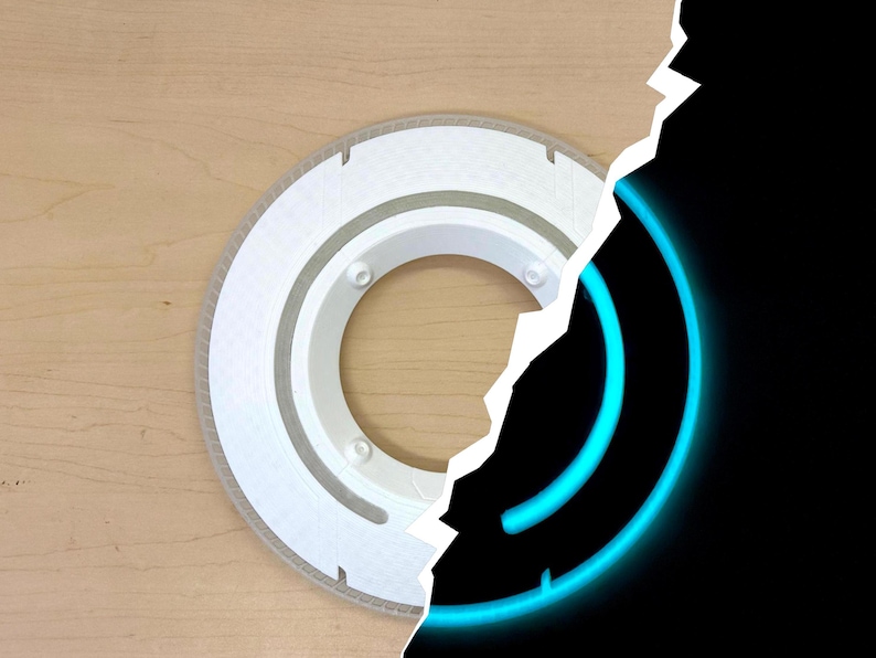May include: A white, circular object with a series of concentric rings and small holes. The object is set against a light brown wooden surface. A section of the image is torn away, revealing a black background with a glowing blue circular design.