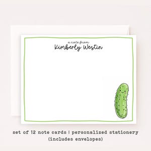 May include: White note card with a green border, featuring the text "a note from Kimberly Westin" and a cartoon pickle illustration. The card is part of a set of 12 personalized stationery items, including envelopes.