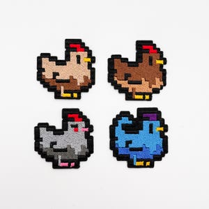 May include: Four pixelated chicken patches in brown, dark brown, grey, and blue. Each patch has a black outline, red comb, and yellow beak and feet. The patches are embroidered and likely for clothing or accessories.
