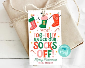 May include: A Christmas gift tag with a red and green elf hat, candy canes, and the text "You Toe-Tally Knock Our Socks Off! Merry Christmas from, Harper".