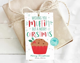 May include: A white gift tag with a red and green Christmas-themed design. It features a cartoon muffin with chocolate chips and the text "Wishing you muffin but a merry Christmas". The tag is personalised with "Coryl" and says "Merry Christmas from, Olivia".