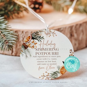 May include: A round, white tag with a floral design and the text "Holiday Simmering Potpourri" with instructions for use. The tag also includes a space to personalise with a name.