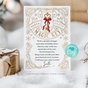 May include: A white card with gold decorative elements and the text "Santa Claus Magic Key". The key is gold with a red bow. The card includes a poem about Santa and Christmas Eve. A gift box is in the background.