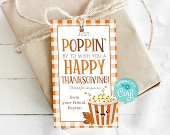 May include: A Thanksgiving gift tag with a red and white checkered background. The tag features a cartoon popcorn bucket with a smiling face and the text "Just Poppin' by to wish you a Happy Thanksgiving! Thanks for all you do! From your friend, Peyton".