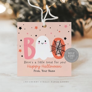 May include: A square, peach-colored Halloween gift tag with the word "BOO" in pink and orange, featuring a ghost and spiderweb. Text reads "Here's a little treat for you! Happy Halloween". Includes a "Self Edit" seal.