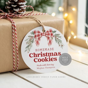 May include: A wrapped gift with a round tag that reads "Homemade Christmas Cookies." The tag features a red and white plaid bow and greenery. The gift is tied with red and white twine.