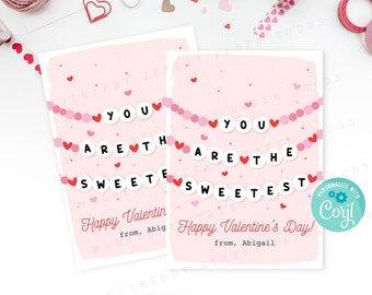 Puede incluir: Tarjeta rosa del Día de San Valentín con una pancarta que dice "Eres el más dulce" con corazones rojos y círculos rosas y blancos. La tarjeta también incluye el texto "¡Feliz Día de San Valentín! de Abigail".