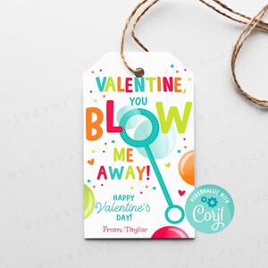 May include: A colorful Valentine's Day gift tag with the text "Valentine, You Blow Me Away!" and a cartoon bubble wand. The tag also includes the text "Happy Valentine's Day!" and "From: Taylor".