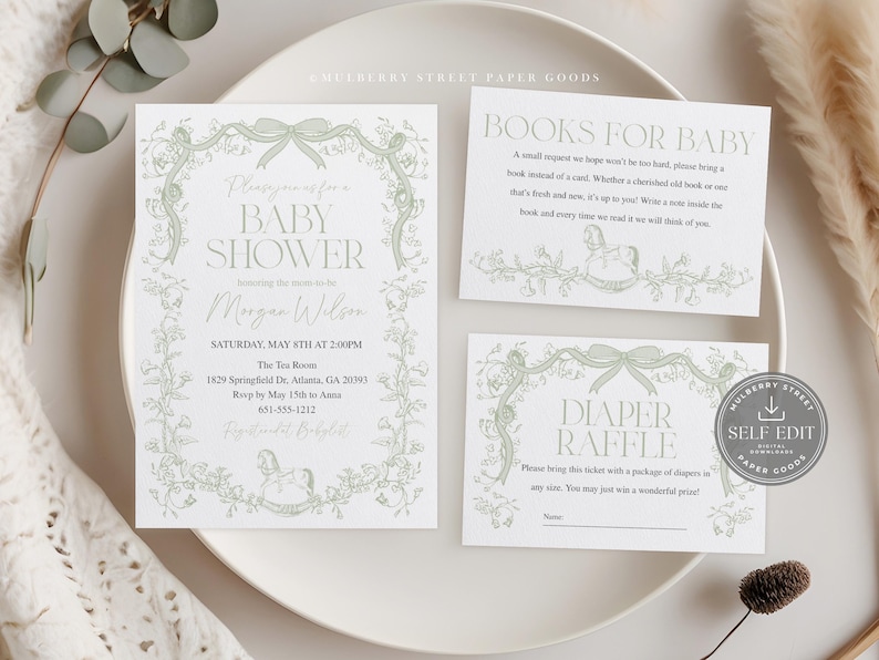 May include: A baby shower invitation suite with a soft green floral design. The invitation, a book request card, and a diaper raffle card are displayed on a white plate. The invitation includes the text "Baby Shower" and event details.
