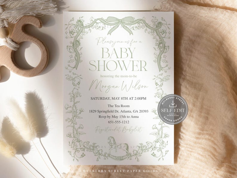 May include: Baby shower invitation with a floral design in light green. The invitation includes the text "Baby Shower" and details for the event, including the date, time, and location in Atlanta, GA. The invitation also has a bow and floral border.